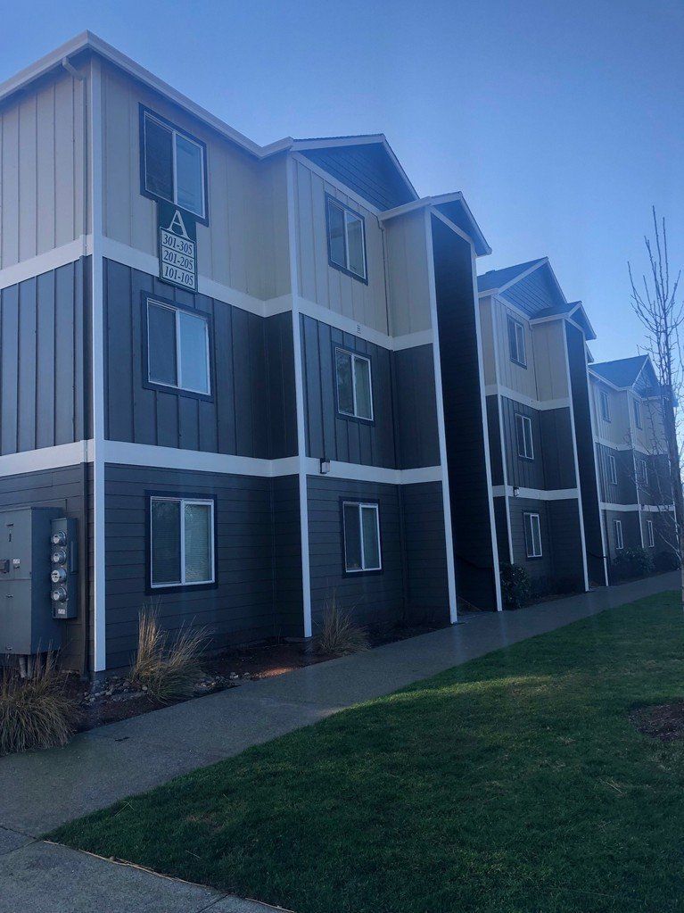 exterior side of building with parked cars