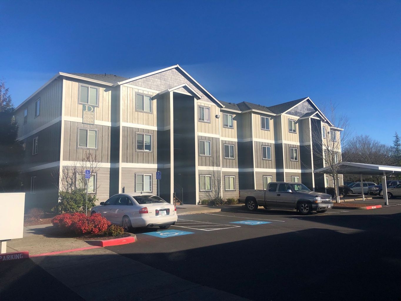 exterior side of building with parked cars