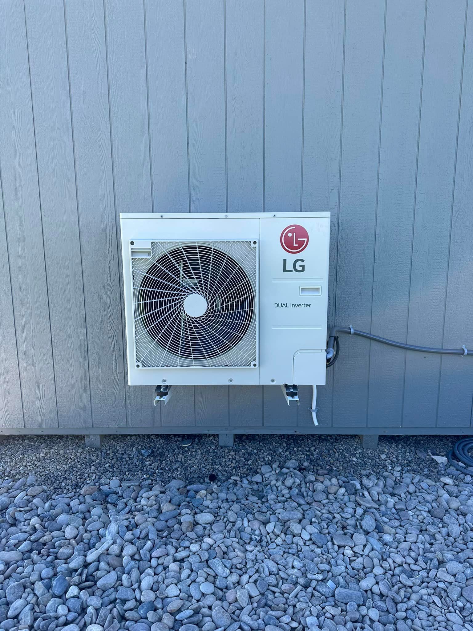 An lg air conditioner is mounted on the side of a building.