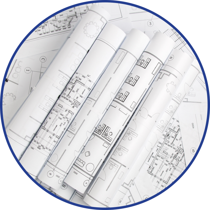 Rolled blueprints on a table, diagrams visible, within a blue circle.