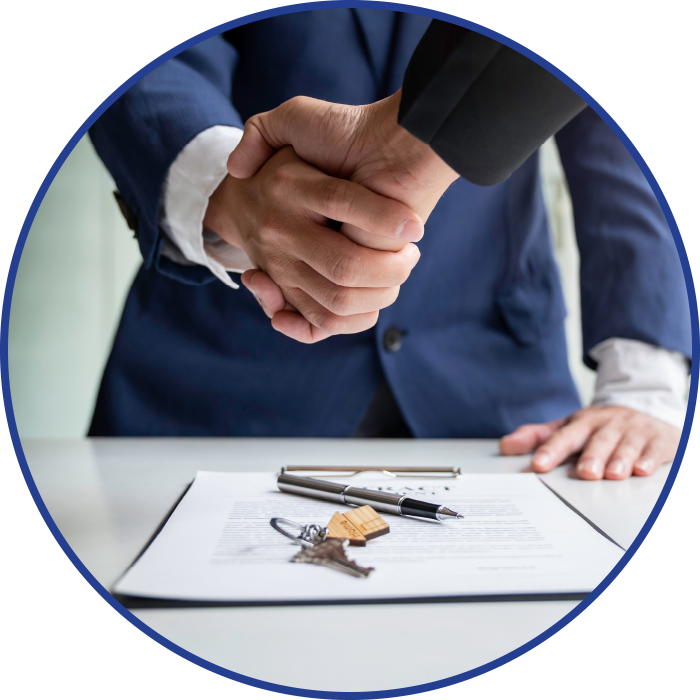 Handshake over a contract with keys, suggesting a real estate deal.