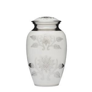 A white vase with silver flowers and leaves on it.