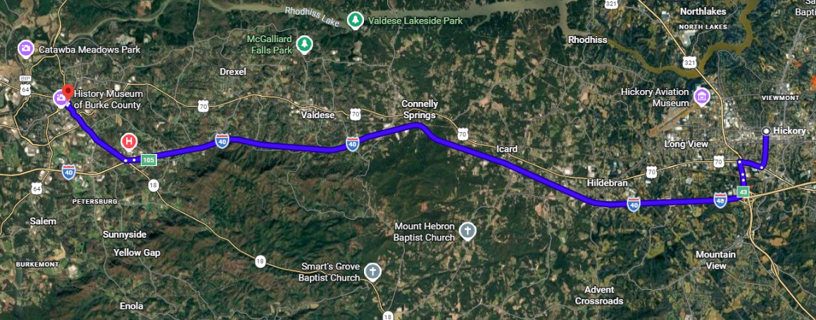 Satellite map with a purple route line stretching west to east across a green landscape.