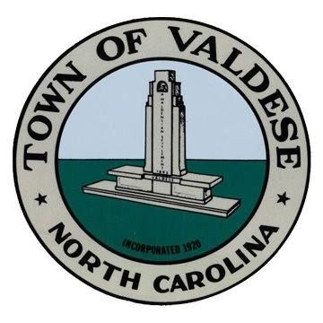 Town of Valdese, North Carolina seal with a monument over a blue and green background