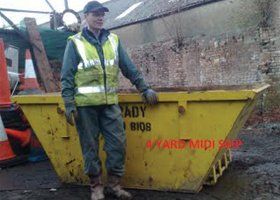 a contractor standing near the skip