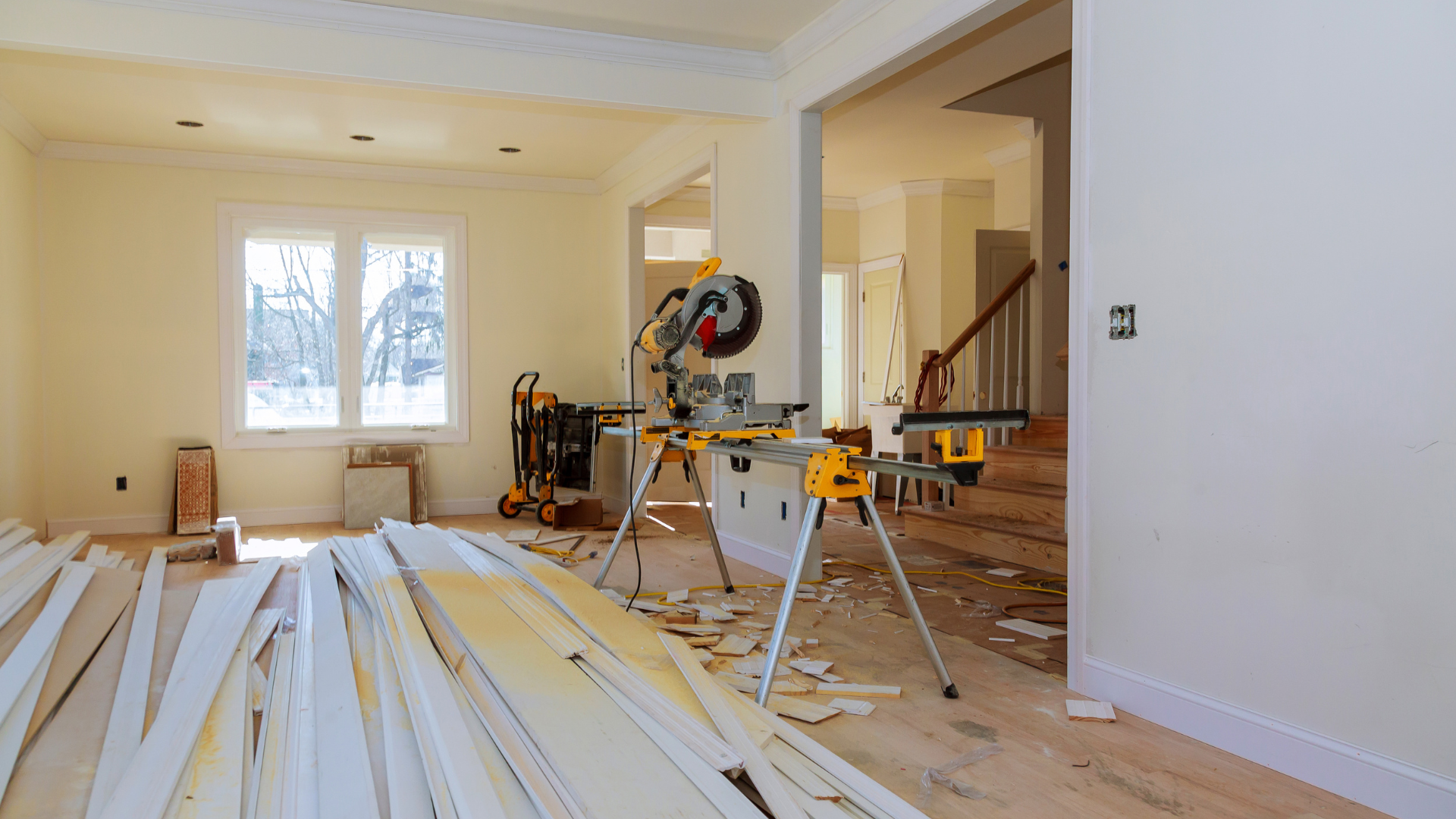 A house is being remodeled and there is a stack of wood on the floor.