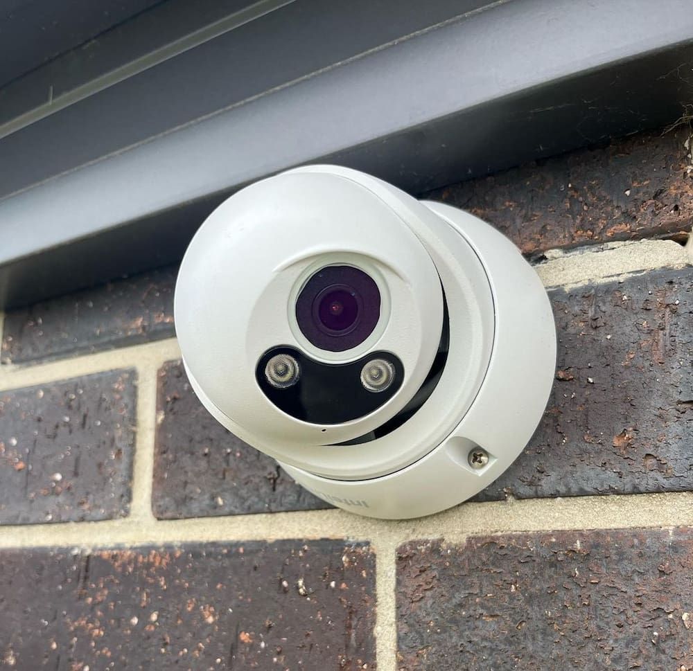 A Security Camera Is Mounted On A Brick Wall — AdvancedOne Electrical in Alfredton, VIC