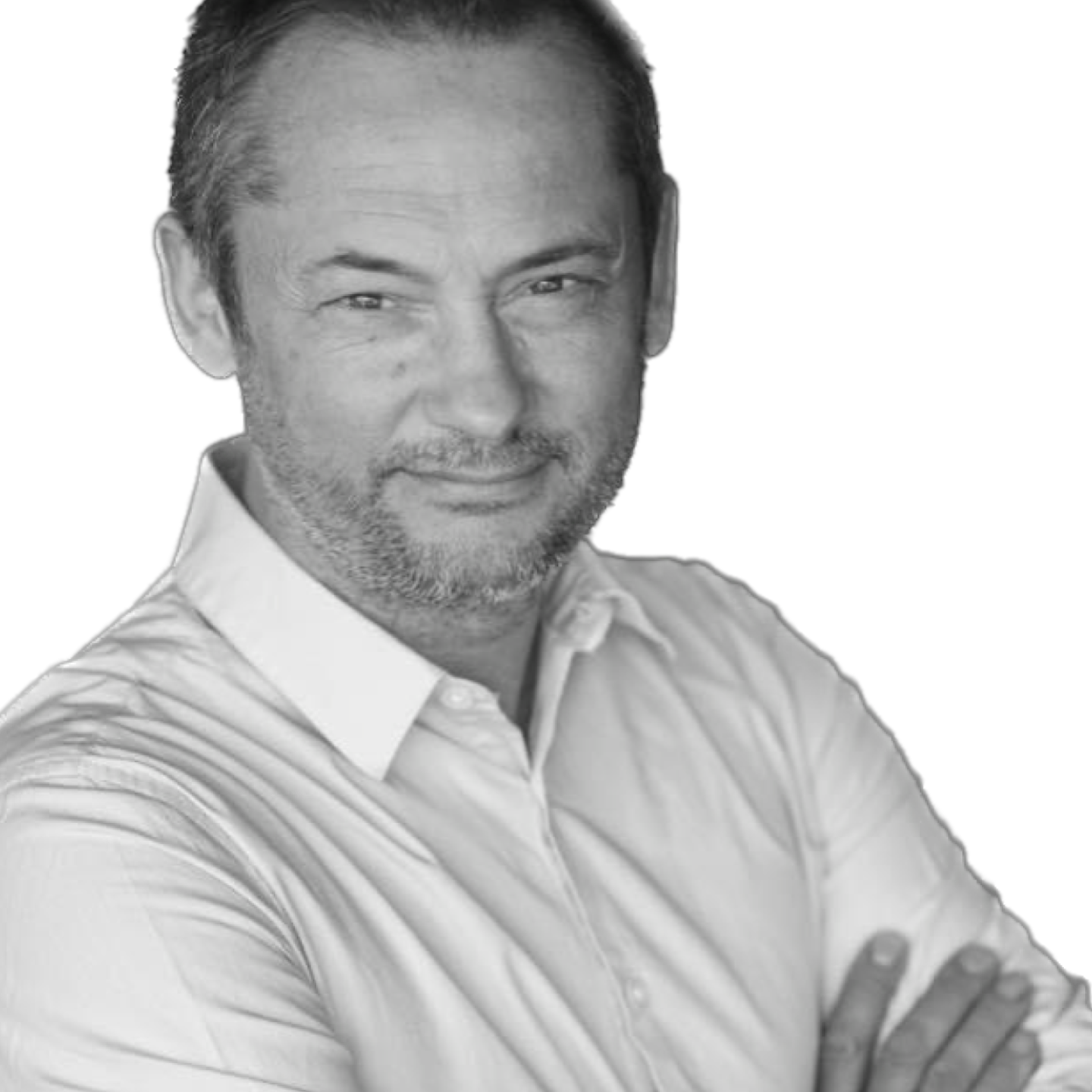 Man with short, graying hair and stubble smiles, arms crossed, in a white shirt, against a white background.