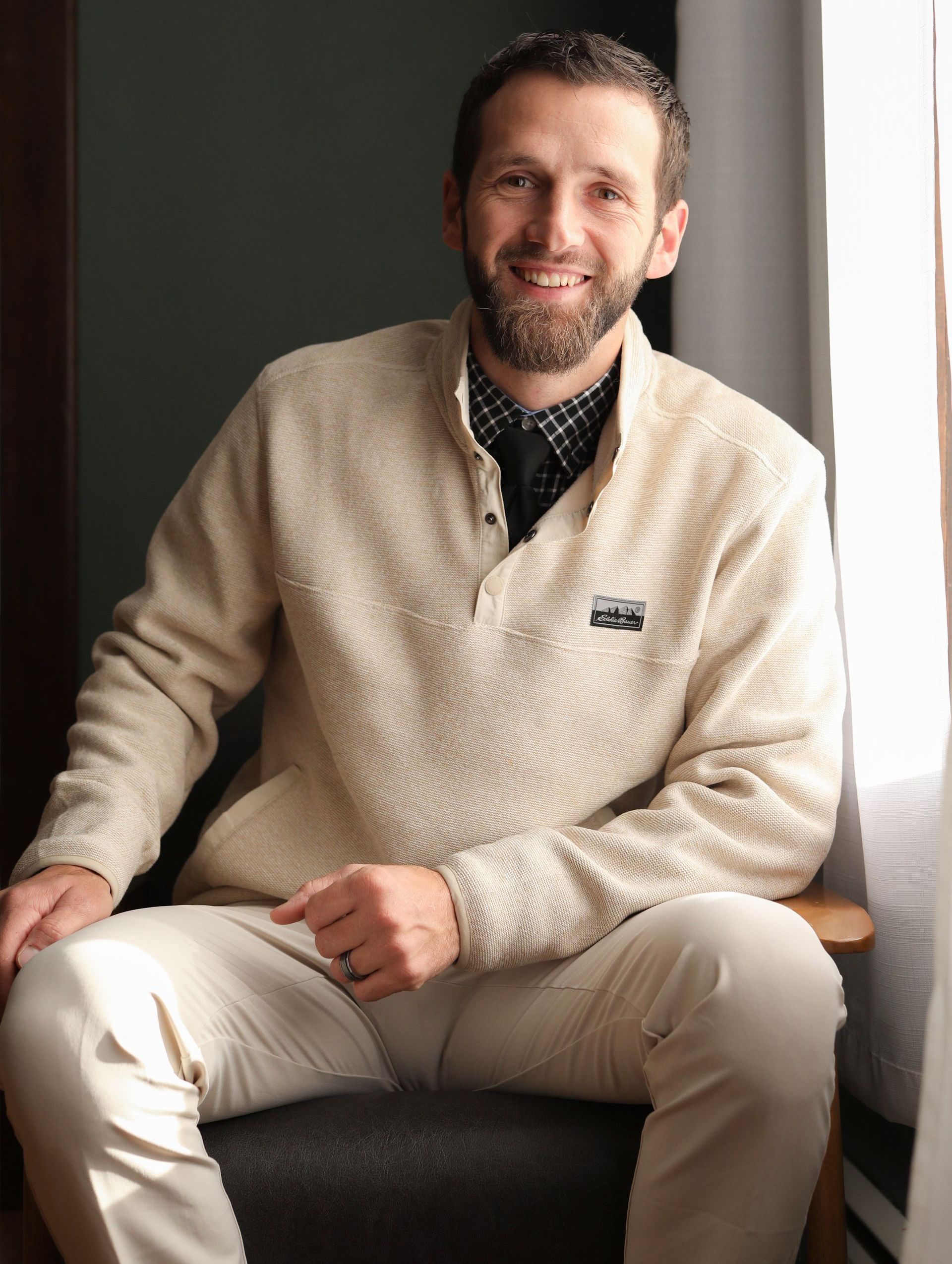 A living room with a couch , chairs , table and fireplace