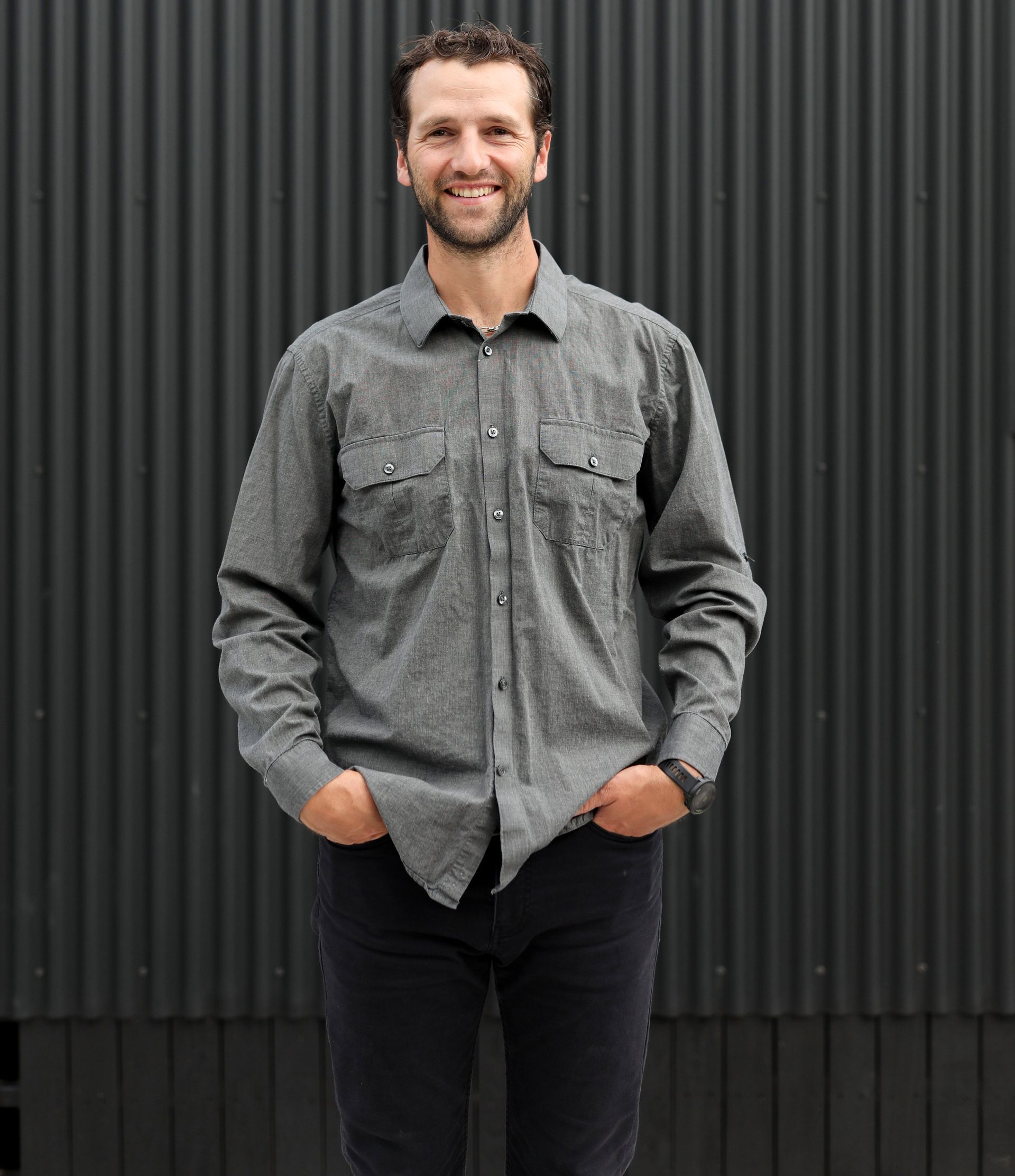 A living room with a couch , chairs , table and fireplace
