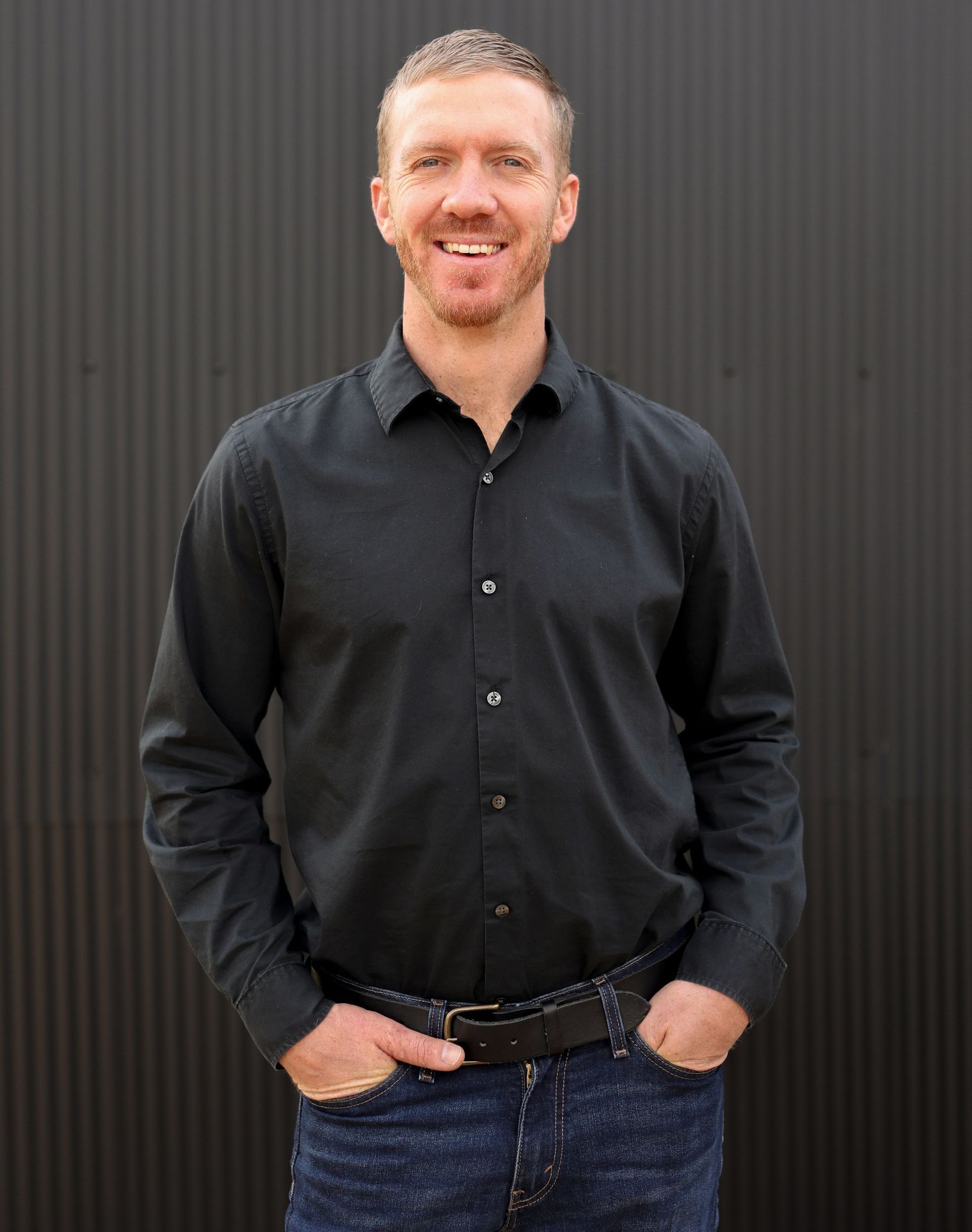 A living room with a couch , chairs , table and fireplace