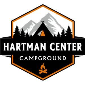 Hartman center campground logo with a tent and mountains in the background