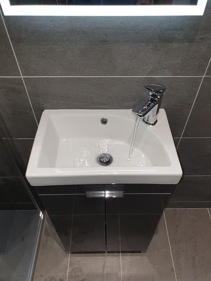 Image of wet room focused on sink with tap