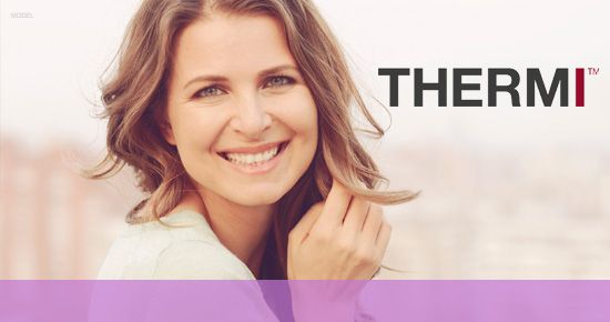 Smiling woman with wavy brown hair, holding her hair, next to the 