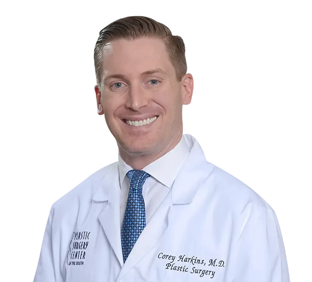 Man in white lab coat with tie, smiling; text reads 