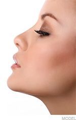 Woman's profile view with closed eyes, long eyelashes, and subtle makeup, looking serene.