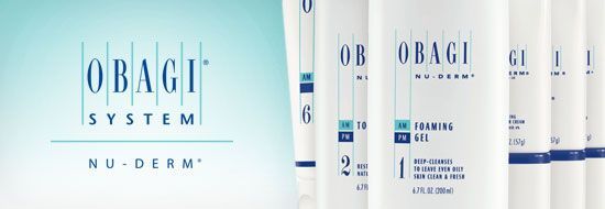Obagi Nu-Derm skincare products. White tubes in a row with the Obagi logo, on a teal and white background.