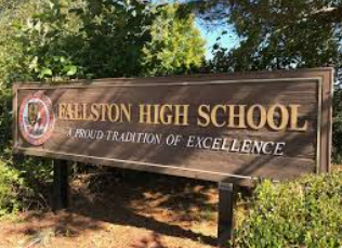 Elliston High School sign with the motto “Proud Tradition of Excellence” in front of trees