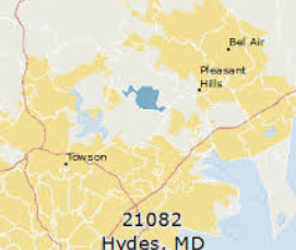 Road 146 sign for Jarrettsville Pike on a sunny suburban street with trees and a curving road