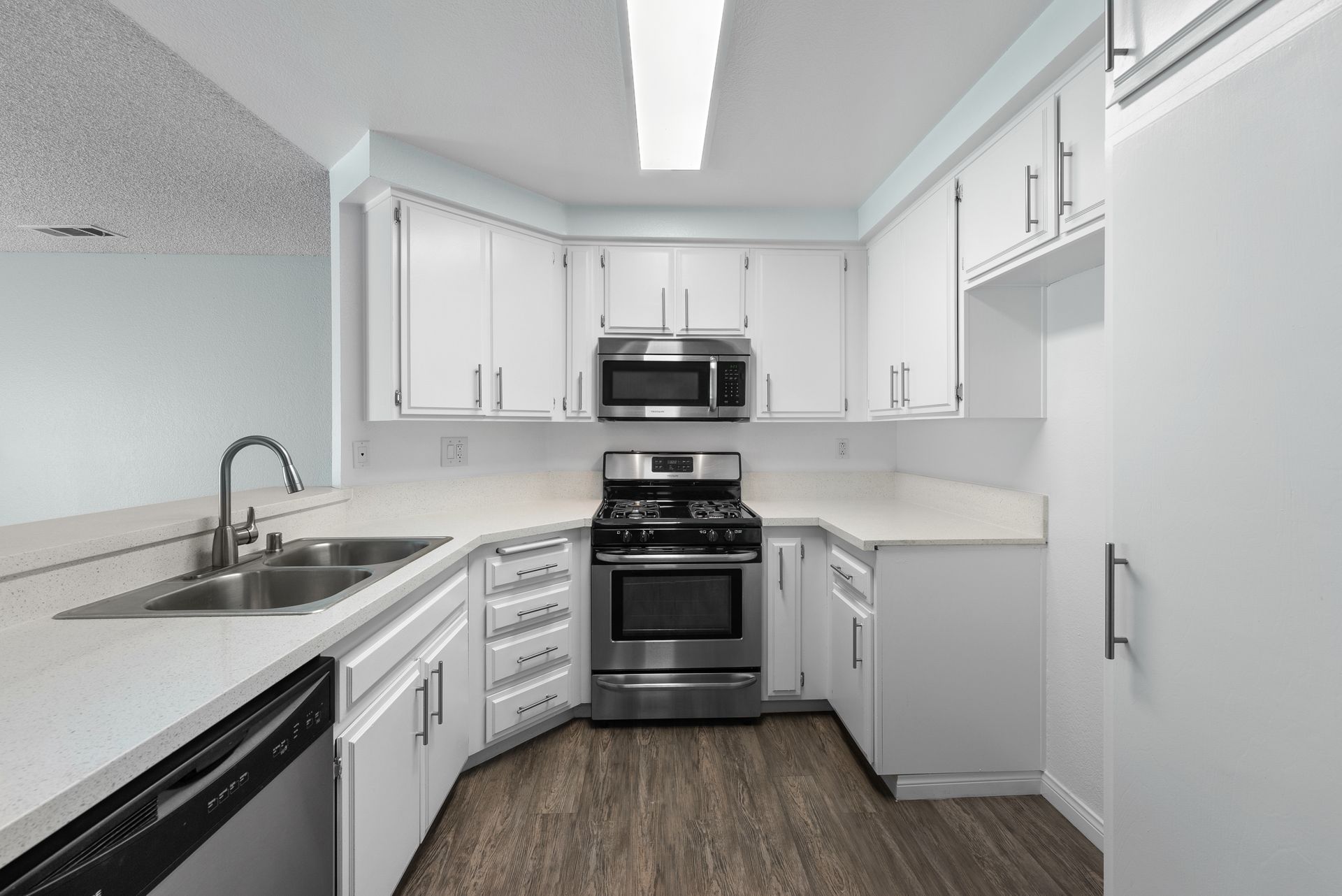 Kitchen with oven, microwave, and cupboards