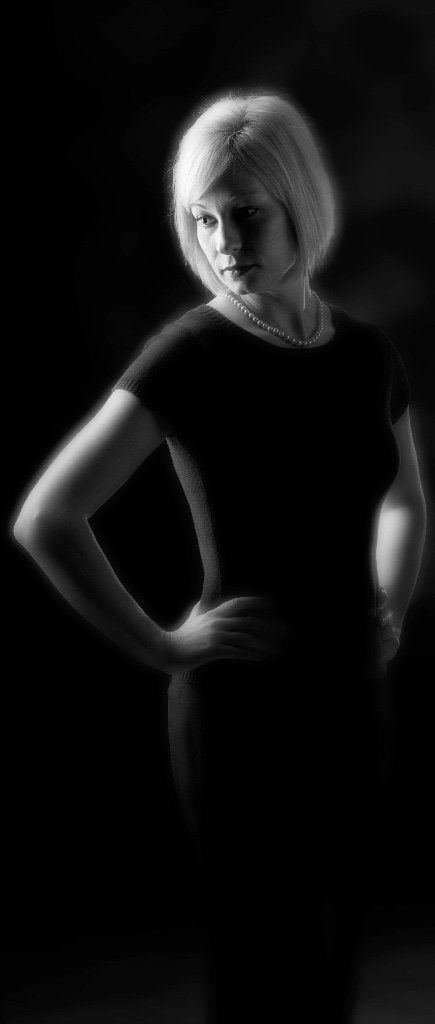 a black and white photo of a woman with her hands on her hips