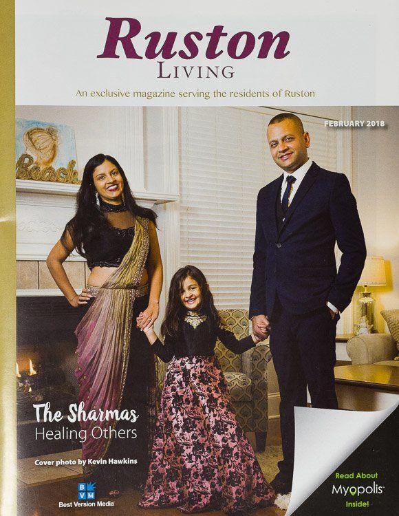 The cover of ruston living magazine shows a family holding hands