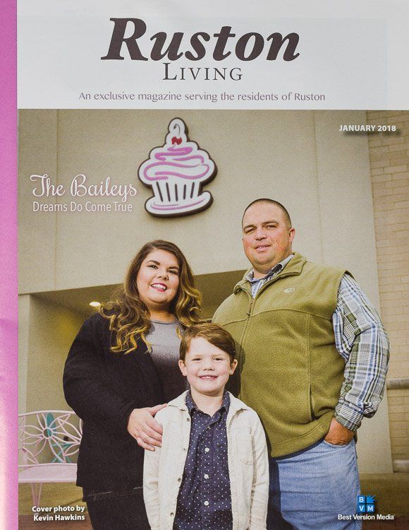 A family is posing for a picture on the cover of a ruston living magazine.