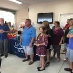 A group of people are standing in a room.