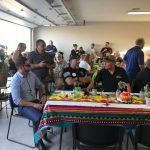 A group of people are sitting at tables in a room.