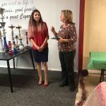 Two women are standing next to each other in a room.