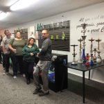 A group of people are standing around a table in a room.