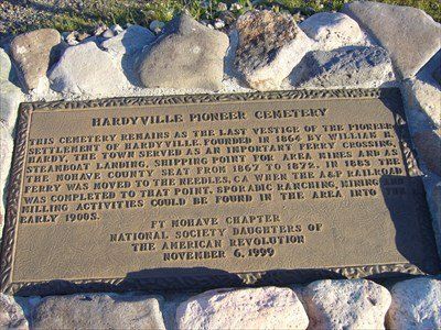 A plaque is sitting on top of a pile of rocks.