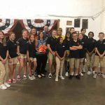 A group of people are posing for a picture in a room.