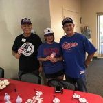 A group of people are standing around a table in a room.