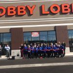 A group of people are standing in front of a store.