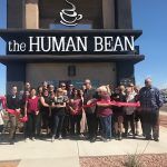 A group of people are standing in front of a building.