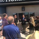 A group of people are standing outside of a building.