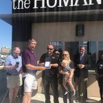 A group of people are standing in front of a building.