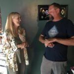 A man and a woman are standing next to each other in a living room.