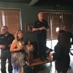 A group of people are standing around a table in a room.