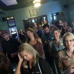 A large group of people are sitting in a room.