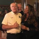 A group of people are standing next to each other in a room.