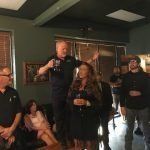 A group of people are standing in a room.