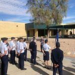 A group of people are standing in front of a building.