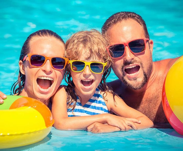 Happy Family Smiling in the Swimming Pool — Port Macquarie, NSW — All Bright Pool Care