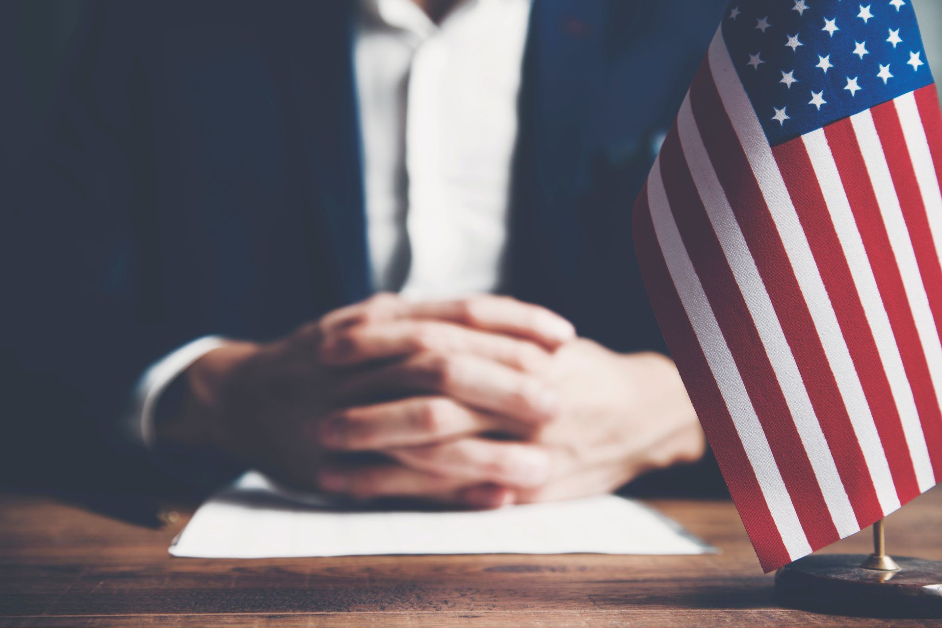 Attorney at desk with U.S. flag representing employment-based immigration in Orlando, Florida.