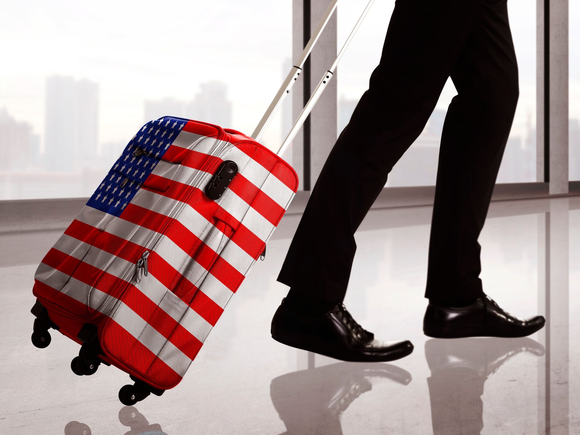 Traveler pulling U.S. flag luggage, symbolizing business immigration guidance in Orlando, Florida.