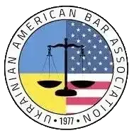The logo for the american ukrainian bar association has a scale of justice on it.