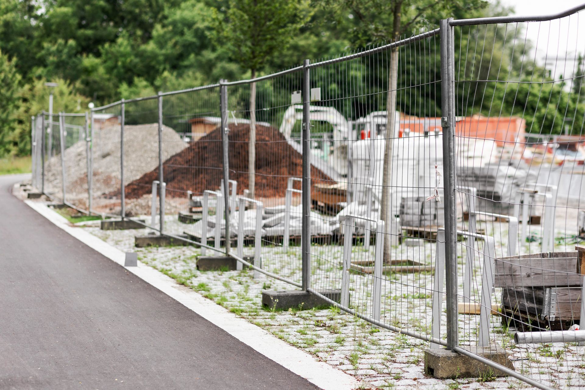 Temporary metal fence installed in a construction site for enhanced safety. Temporary metal fence installed in a construction site for enhanced safety.