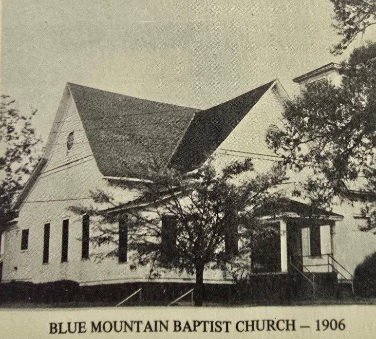 Blue Mountain Baptist Church in 1906: a white wooden church with a peaked roof and a small porch.